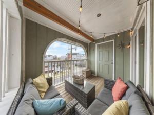 a living room with a couch and a balcony at Sea The Good condo in Carolina Beach