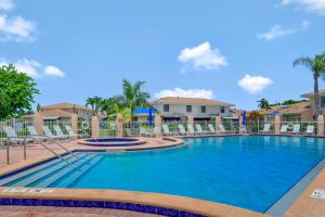 a swimming pool at a resort with chairs at San Marco Villas H-3 in Marco Island