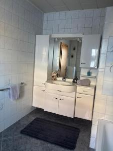 a white bathroom with a sink and a mirror at Ferien- & Monteurswohnung Krüger Werra Suhl Tal in Raßdorf