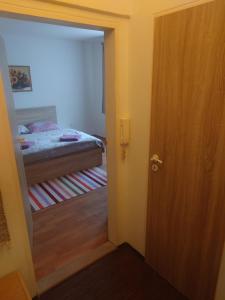 a door leading to a bedroom with a bed at Zukalka 2KK - 2 in Ostrava