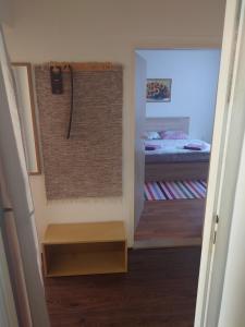 a hallway with a shower in a bedroom with a bed at Zukalka 2KK - 2 in Ostrava