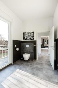 a bathroom with a tub and a toilet in it at Modernes Apartment in Mistelgau 3 in Mistelgau