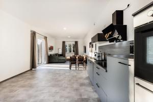 a kitchen with a counter and a living room at Modernes Apartment in Mistelgau 3 in Mistelgau