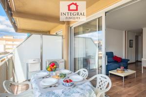 a table and chairs on a balcony with a dining room at Why Not Apartment Palamós in Palamós