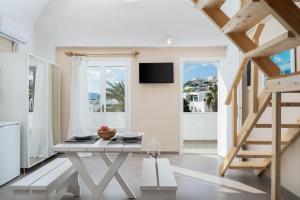 a living room with a table and a tv at Santa Irini 2 in Vourvoúlos
