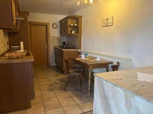 a kitchen with a table and chairs in a room at Ferien- & Monteurswohnung Krüger Werra Suhl Tal in Raßdorf