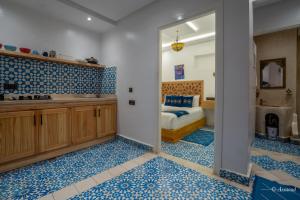 a room with a bedroom with a tub and a bed at Dar jawhara in Chefchaouen +137 photos