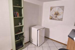 a kitchen with a white refrigerator in a room at Private room with own bathroom in Harsum