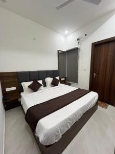 a bedroom with a large bed in a room at Hotel Divaa Inn in Mathura