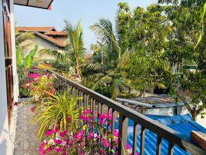 a balcony with pink flowers on a resort at Fourcoock Villa in Kosgoda