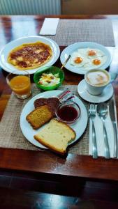 a table with plates of breakfast food on it at Giagia Evgenia in Vitsa