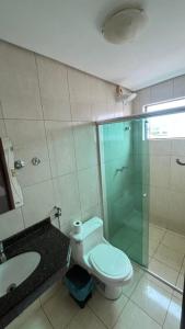 a bathroom with a toilet and a glass shower at Hotel Eduardus in Palmas +19 photos