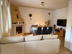 a living room with a white couch and a fireplace at Casa do Sol in Safara