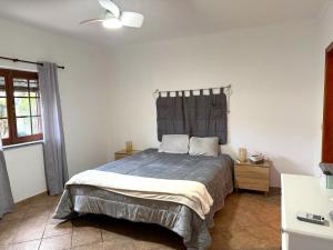 a bedroom with a bed and a ceiling fan at Casa do Sol in Safara +16 photos