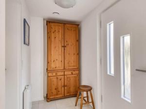 a hallway with a wooden door and a stool at Charme Appartment in Freiburg im Breisgau