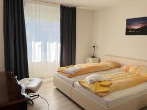 a bedroom with two beds and a window at Ascona: ORTO DEGLI ANGIOLI in Ascona