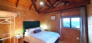 a bedroom with a bed in a room with a window at 7 on Kloof in Mossel Bay +21 photos