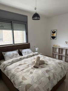 a bedroom with a large bed with two pillows on it at Royal Park A&7 Deluxe, swim pool - by G&P suites in Eilat +28 photos