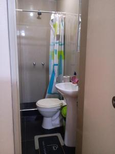 a bathroom with a toilet and a sink at Arequipa- LaPampilla in La Pampilla