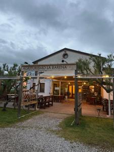 a building with tables and benches in front of it at Agriturismo La Barena in Jesolo