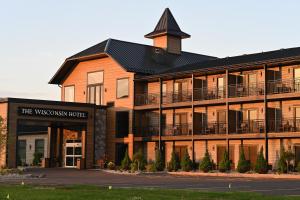 a building with a sign for the wesleyan hotel at The Wisconsin Hotel & Conference Center in Wisconsin Dells