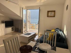 a living room with a couch and a view of the ocean at Apartmani BOBO in Kotor