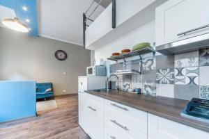a kitchen with white cabinets and a blue refrigerator at D53 Apartments in Budapest