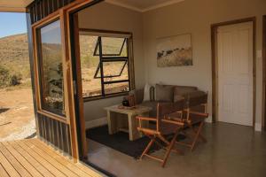 a living room with a couch and a table at Valley View Escape in Uitkeer