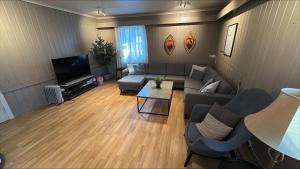 a living room with a couch and a tv at Stayover Lista in Farsund