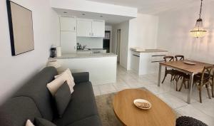 a living room and kitchen with a couch and a table at Ferienwohnung C12 in Orselina