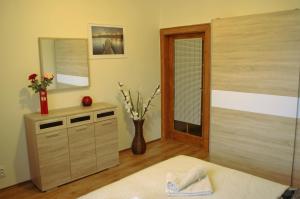 a bedroom with a bed and a vase with flowers at Spacious Prague View Apartment in Prague