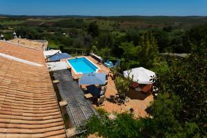 an aerial view of a house with a swimming pool and umbrellas at Quinta Velha by GT House in Portimão