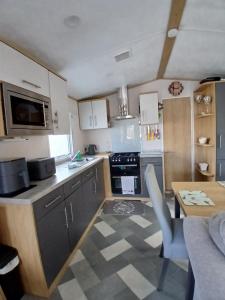 a small kitchen with a table and a counter top at The Robin's Nest in Fochabers