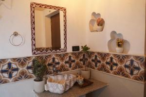 a bathroom with a sink and a mirror at Mud & Meadows- A Satvik Farmstay, Jamshedpur in Jamshedpur +30 photos
