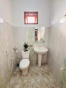 a bathroom with a toilet and a sink at Fourcoock Villa in Kosgoda +74 photos