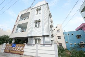 a white house with a fence in front of it at Sri Padam HomeStay in Tirupati