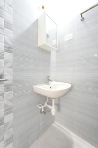 a bathroom with a sink and a mirror at Sri Padam HomeStay in Tirupati +30 photos