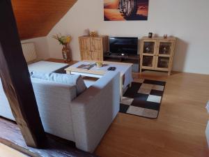 a living room with a couch and a table at Zukalka 2KK - 3 in Ostrava