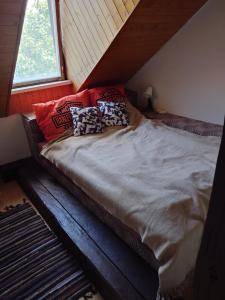 a bed with pillows on it in a attic at Zukalka 2KK - 3 in Ostrava