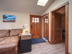 a living room with a couch and a table at Going Coastal AB - Oceanfront - Pet Friendly in Port Renfrew +32 photos