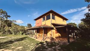 a house that is on the side of a field at Amazing house with chalet and a beautiful garden in Sêrro