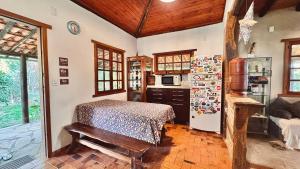 a kitchen with a table and a refrigerator at Amazing house with chalet and a beautiful garden in Sêrro