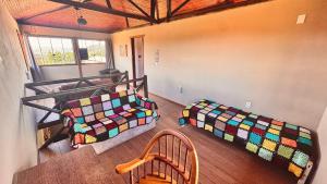 a room with two beds and a table and chairs at Amazing house with chalet and a beautiful garden in Sêrro