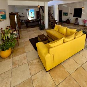 a yellow couch sitting in a living room at Casa da Juma in Fortim
