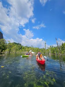 a group of people riding in kayaks on a river at Safary Tour in Ban Ta Kun