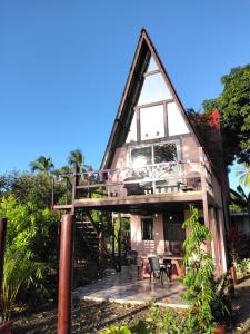 a house with a staircase up to the roof at Cabañas Martina Surf Playa Guanico in Pedregal