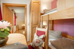 a room with two bunk beds and a chair at Dorfergut in Weisspriach
