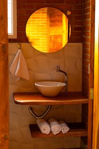 a bathroom with a sink and a mirror at ChapadaFlats in Chapada dos Guimarães