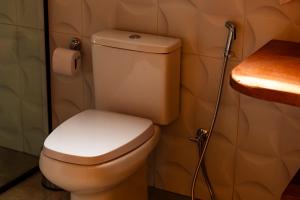 a bathroom with a toilet and a shower at ChapadaFlats in Chapada dos Guimarães +7 photos