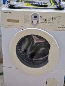 a white washing machine with its door open at Dar Mima in Tunis